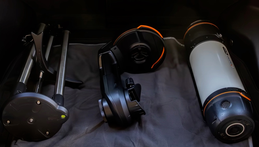 The Celestron Origin ni three parts, tripod, mount and telescope, in the back of a vehicle.