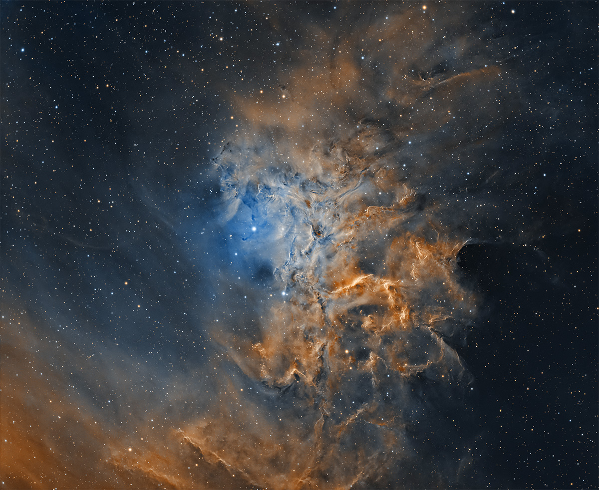 Sh2-136 large dusty area with glowing star lighting it up yellow