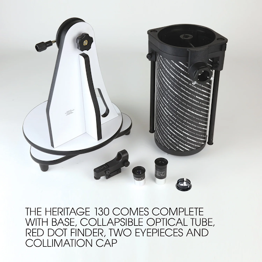 Unboxed Sky-Watcher Heritage 130P telescope set showing the tabletop Dobsonian base, collapsed optical tube assembly, red dot finder, two eyepieces, and a collimation cap.